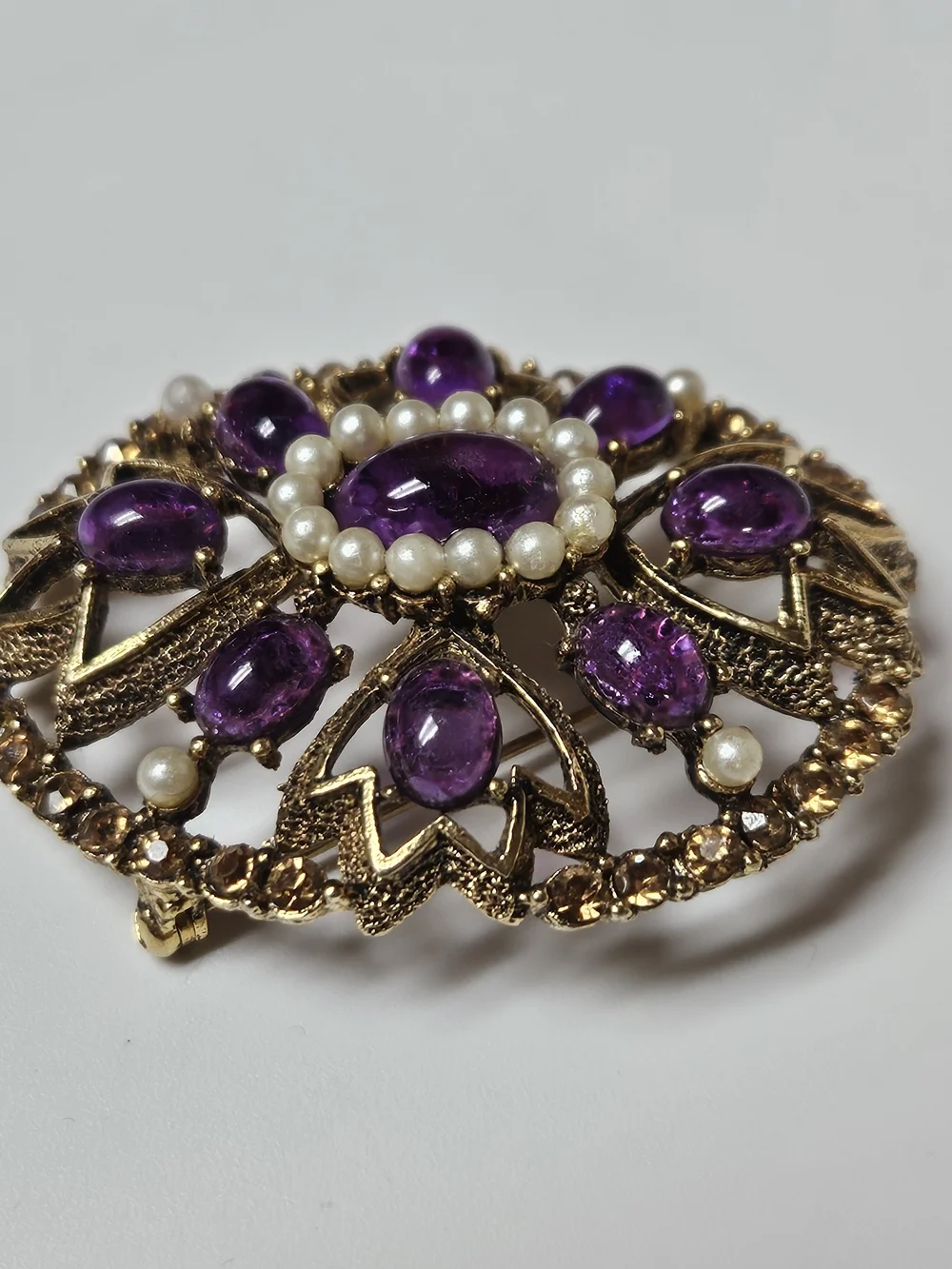 Gold-Tone Brooch with Purple Cabochons and Pearl Halo